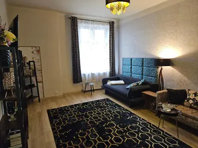 a living room with a couch and a rug at Sara -Mikołajska - Rynek - Netflix Hydromassage in Kraków