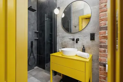 a bathroom with a yellow sink and a mirror at Old Town Studio Good Vibes by Noclegi Renters in Kraków