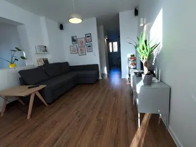 a living room with a black shelf with potted plants at M37 x Fabryczna in Limanowa