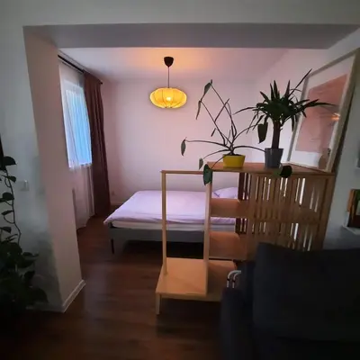 a bedroom with a bed and a table with plants at M37 x Fabryczna in Limanowa