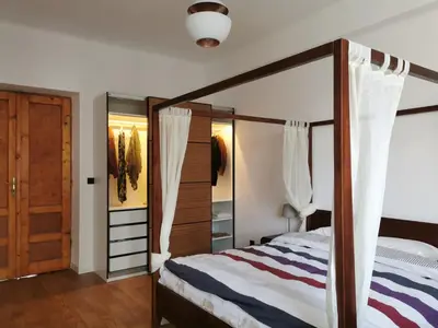 an open door to a bedroom with a bed at Designer Apartment 110m2 with King Size Beds & Equipped Kitchen in Kraków