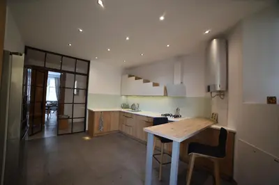 a kitchen with a stainless steel refrigerator and appliances at Designer Apartment 110m2 with King Size Beds & Equipped Kitchen in Kraków