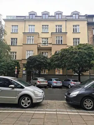 a group of cars parked in front of a building at Designer Apartment 110m2 with King Size Beds & Equipped Kitchen in Kraków