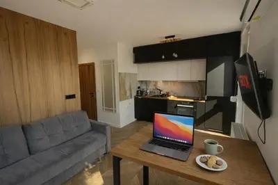 a living room with a couch and a table at Garden Apartment Self Check-in - Bezklucz kropka info in Kraków