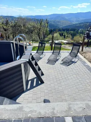 a group of chairs sitting on a patio at apartament simonka z jacuzzi zawoja in Zawoja