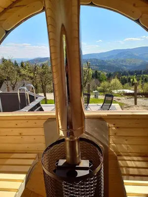 a large window in a wooden cabin with a juicer at apartament simonka z jacuzzi zawoja in Zawoja