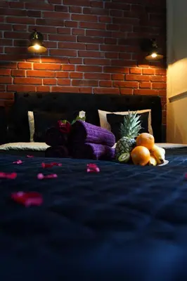 a bed with fruits and vegetables on top of it at Spa Bath Apartment in Kraków