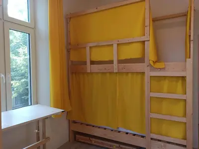 a bunk bed in a room with a window at Evergreen Hostel Krakow in Kraków