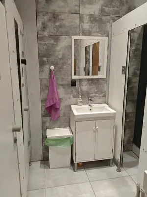 a bathroom with a sink and a mirror at Evergreen Hostel Krakow in Kraków