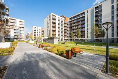 a park with benches and buildings in a city at Wrocławska Two Bedroom Apartment in Kraków