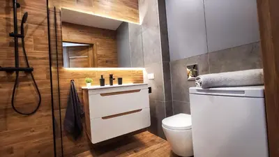 a bathroom with a white sink and a toilet at Wrocławska Two Bedroom Apartment in Kraków