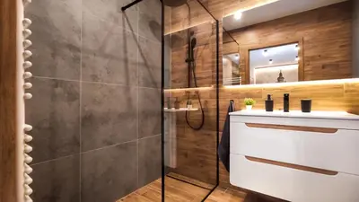 a bathroom with a shower and a sink and a mirror at Wrocławska Two Bedroom Apartment in Kraków