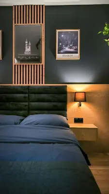 a bedroom with a bed and a tv on the wall at Wrocławska Two Bedroom Apartment in Kraków