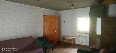 a living room with a couch and a table and a window at Stare Sioło in Wysokie