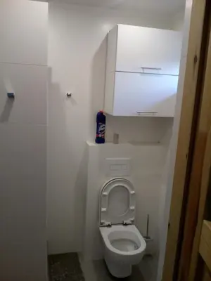 a small bathroom with a toilet with the lid up at Stare Sioło in Wysokie