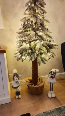 two stuffed animals standing next to a christmas tree at Dom Pod Gaikiem in Łękawica