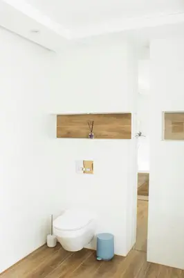 a bathroom with a white toilet and a sink at Dom Pod Gaikiem in Łękawica