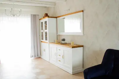 a bathroom with a white cabinet and a window at Dom Pod Gaikiem in Łękawica