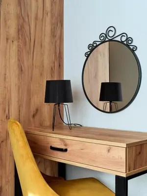 a mirror and a desk with two lamps on it at 1891 Garni Hotel in Kraków