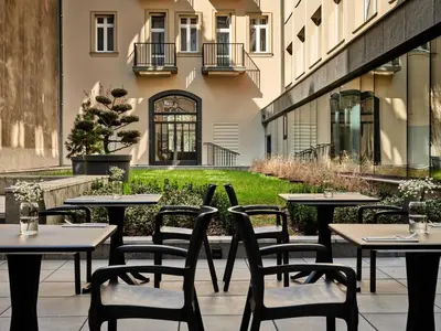 a row of tables and chairs on a patio at 1891 Garni Hotel in Kraków