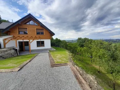 a house with a view of a yard at Domki nad Stawami in Ujanowice