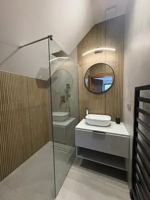 a bathroom with a sink and a mirror at Domki nad Stawami in Ujanowice