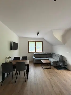 a living room with a couch and a table at Domki nad Stawami in Ujanowice
