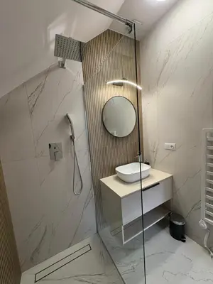a bathroom with a sink and a mirror at Domki nad Stawami in Ujanowice