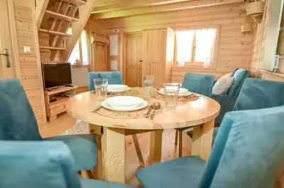a dining room with a table in a tiny house at Domek na Groniku in Zubrzyca Górna