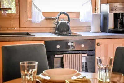 a kitchen with a table and a stove top oven at Domek na Groniku in Zubrzyca Górna