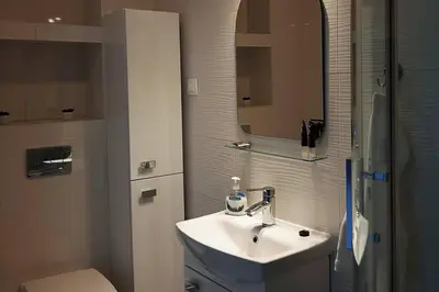 a bathroom with a sink and a toilet at Apartament z tarasem - Appartment with tarace in Kraków