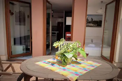 a wooden table with a vase of flowers on a table at Apartament z tarasem - Appartment with tarace in Kraków