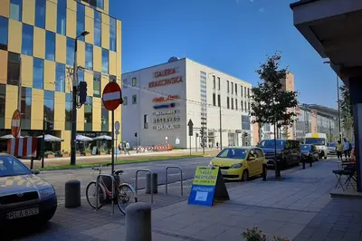 a city street with cars parked on the side of the road at Apartament z tarasem - Appartment with tarace in Kraków