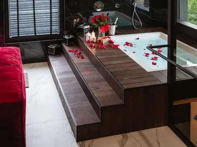 a bathtub with candles and flowers in a bathroom at Art Penthouse with Jacuzzi - Krakow Center in Kraków