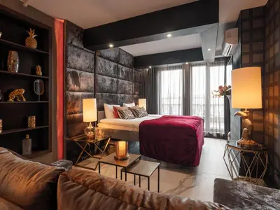 a hotel room with a bed and a couch at Art Penthouse with Jacuzzi - Krakow Center in Kraków