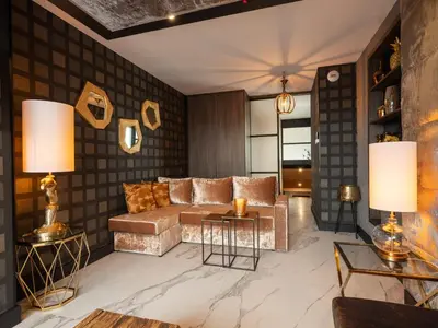 a living room with a couch and tables at Art Penthouse with Jacuzzi - Krakow Center in Kraków