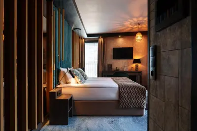 a hotel room with a bed and a window at Art Penthouse with Jacuzzi - Krakow Center in Kraków