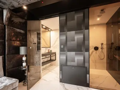 a bathroom with a shower with a glass wall at Art Penthouse with Jacuzzi - Krakow Center in Kraków