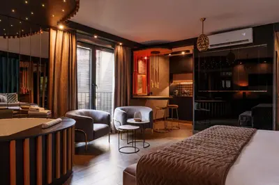 a hotel room with a bed and a bar at Art Penthouse with Jacuzzi - Krakow Center in Kraków