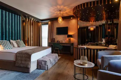 a hotel room with a bed and a bar at Art Penthouse with Jacuzzi - Krakow Center in Kraków