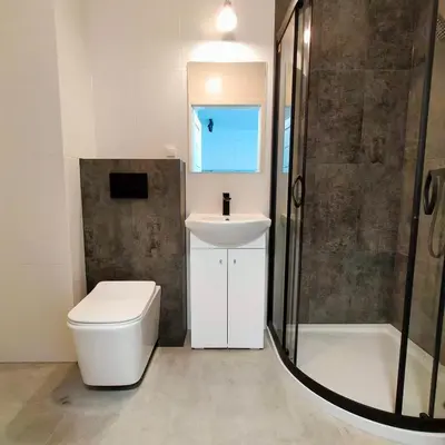 a bathroom with a toilet and a sink and a shower at APARTAMENT HELSINKI in Kraków