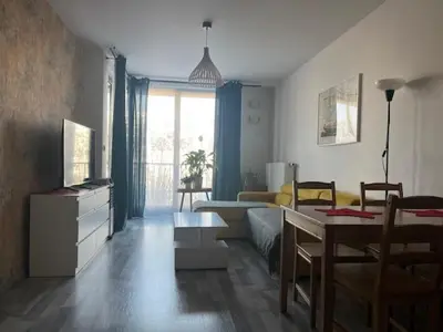a living room with a couch and a table at APARTAMENT HELSINKI in Kraków