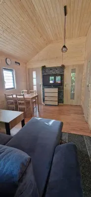 a living room with a couch and a table at Chatka pod orzechem in Spytkowice