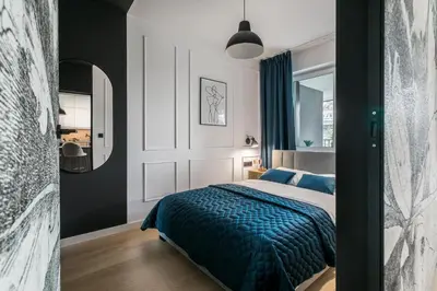 a bedroom with a bed with a blue blanket at Barska 69 Apartments in Kraków