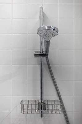 a shower head with three baskets in a bathroom at Barska 69 Apartments in Kraków