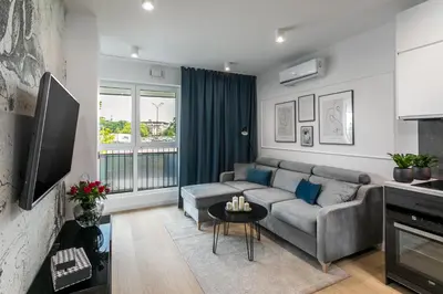 a living room with a couch and a table at Barska 69 Apartments in Kraków
