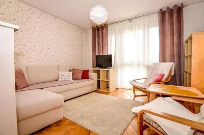 a living room with a couch and a tv at Apartament w Alejce in Rabka