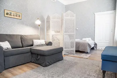 a living room with a couch and a bed at HOUSEHOST Apartment :Zacisze Street in Kraków