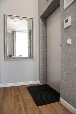 a mirror on a wall in a room at HOUSEHOST Apartment :Zacisze Street in Kraków