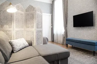 a living room with a couch and a flat screen tv at HOUSEHOST Apartment :Zacisze Street in Kraków